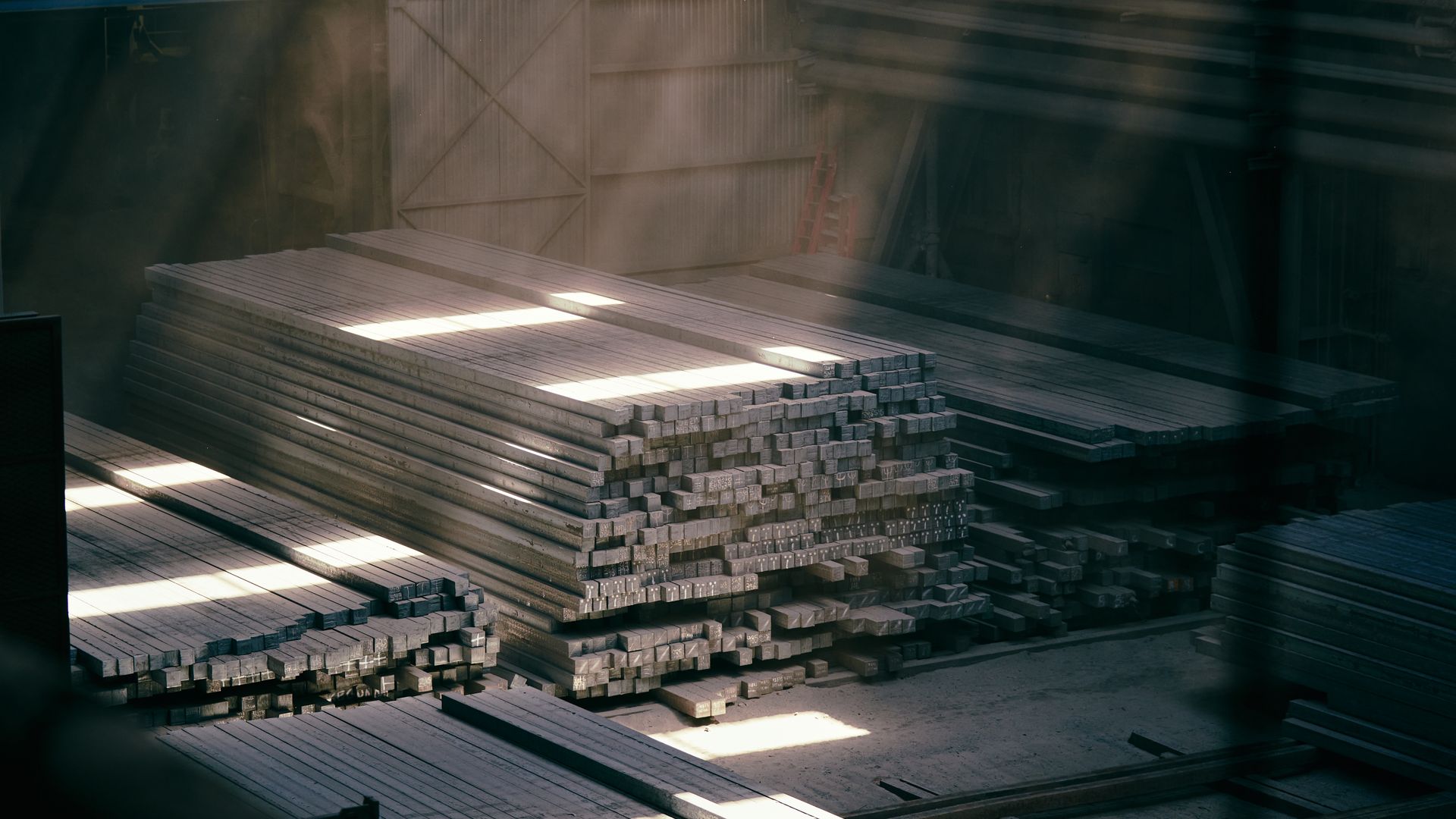 Stacked steel sections in a warehouse