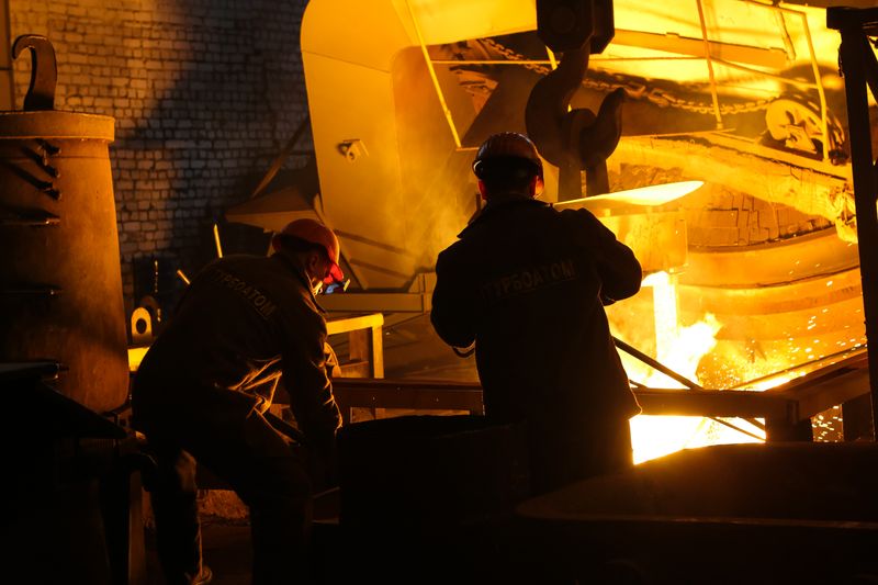 Workers at a steel furnace